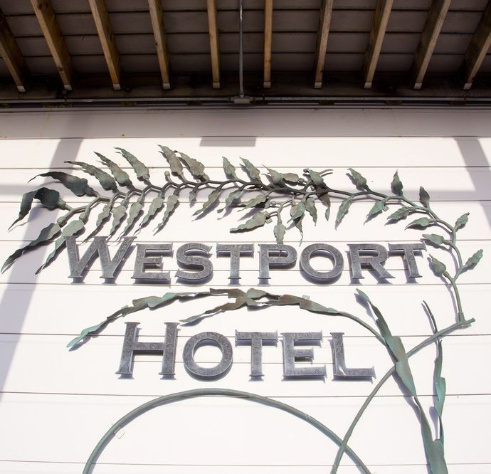 A sign for westport hotel with leaves on it