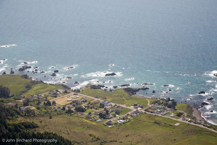 An aerial view of a small town near the ocean