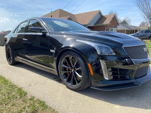 glossy black cadillac after an exterior detail