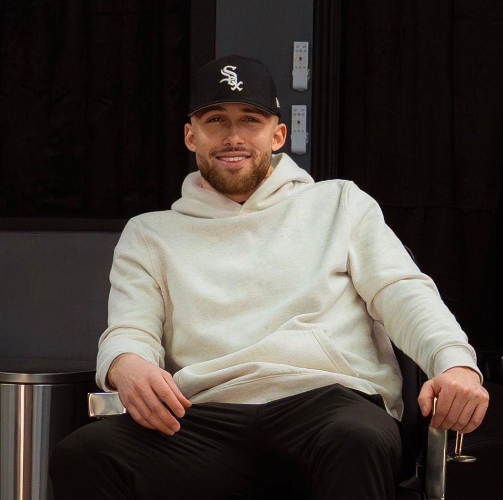 Barber shaves a man's beard with a straight razor, close-up shot.