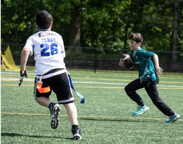 Basketball about to go through a hoop.