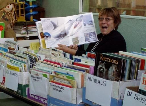 A woman is reading a book about raccoons