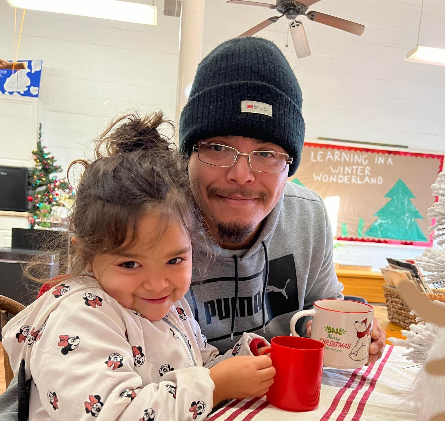 A man and a little girl are sitting at a table.