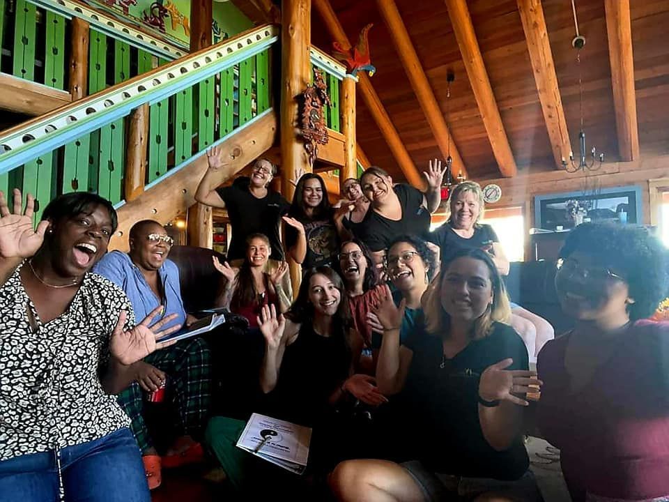 A group of women are posing for a picture in a cabin.