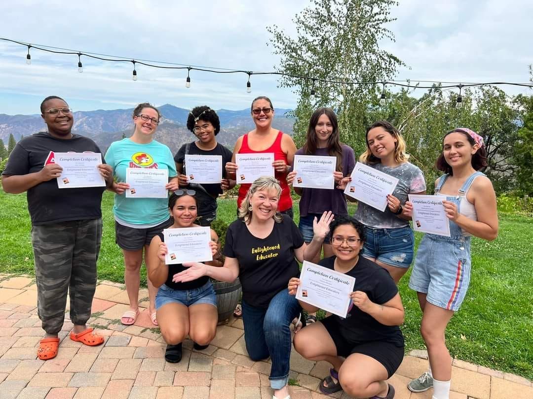 A group of people are posing for a picture while holding certificates.