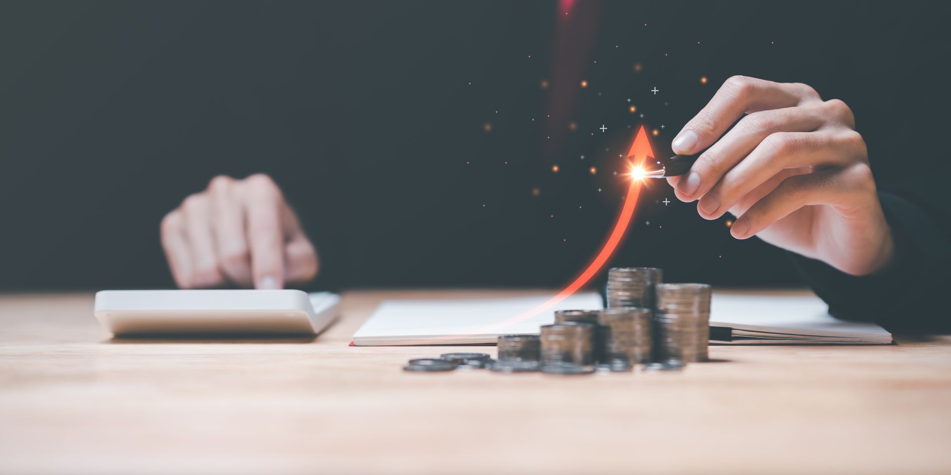 Person calculating finances, with coins and an upward pointing arrow representing growth.