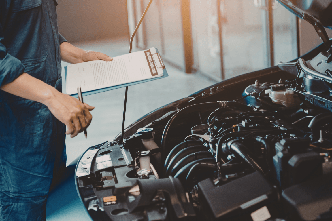 a mechanic doing a pre-purchase inspection on a car