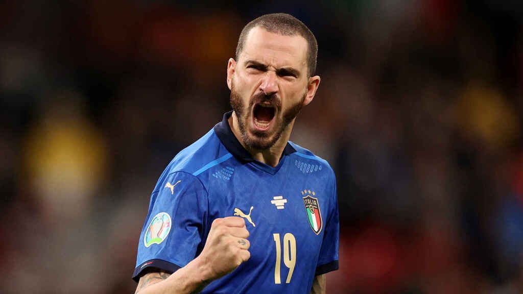 An Italian soccer player is celebrating a goal during a soccer match.