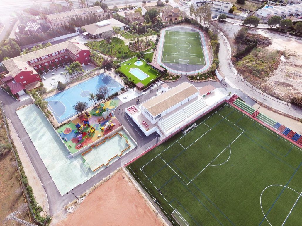 An aerial view of Spain Rush-SPF soccer field and a swimming pool