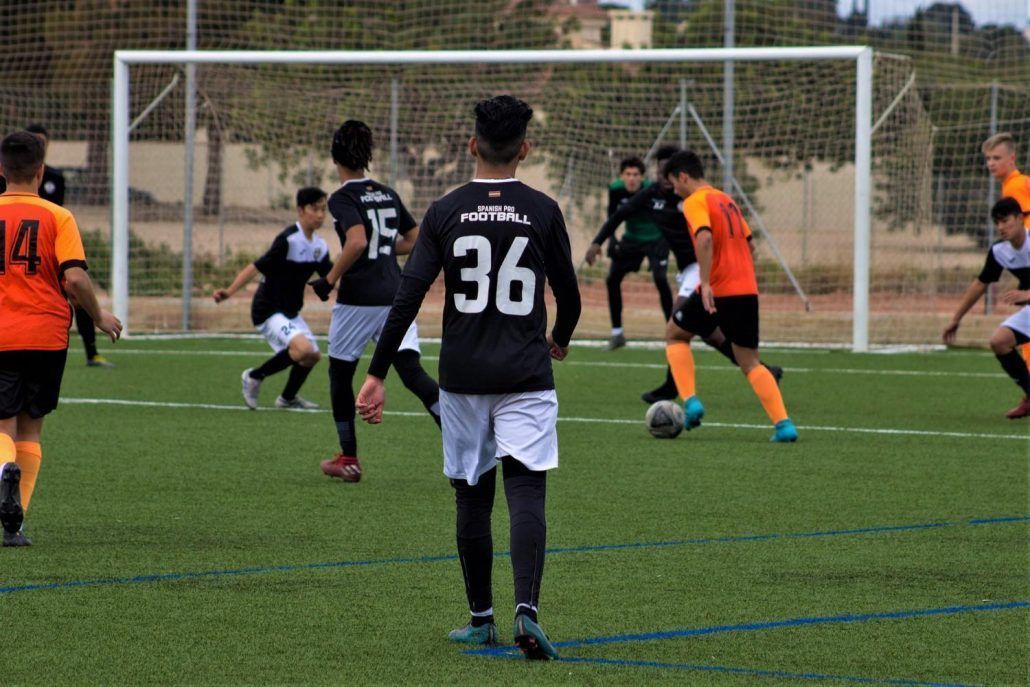 A group of young men are playing soccer on a field.