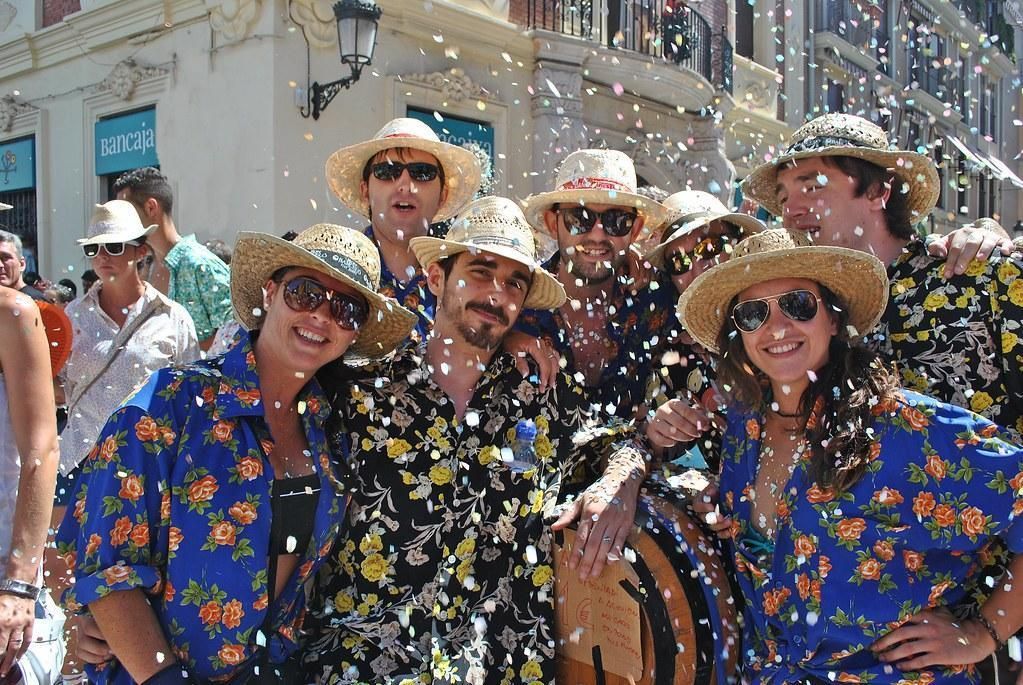 A group of people wearing hats and sunglasses are posing for a picture