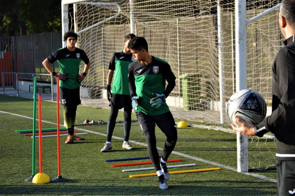 A group of young men are playing soccer on a field.