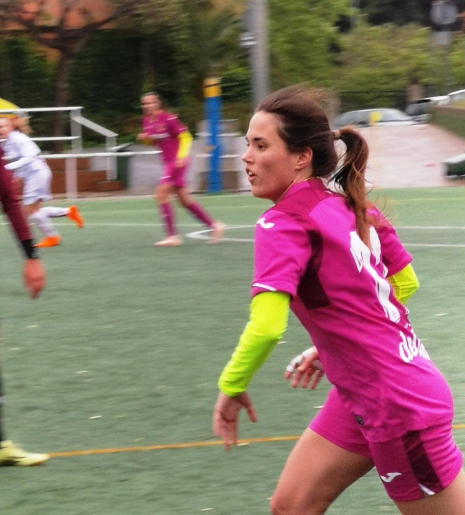 A woman in a pink jersey with the number 8 on it