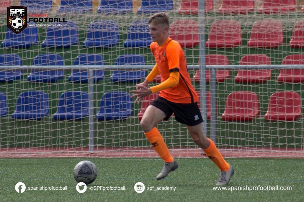 Yarik is playing soccer on a field.