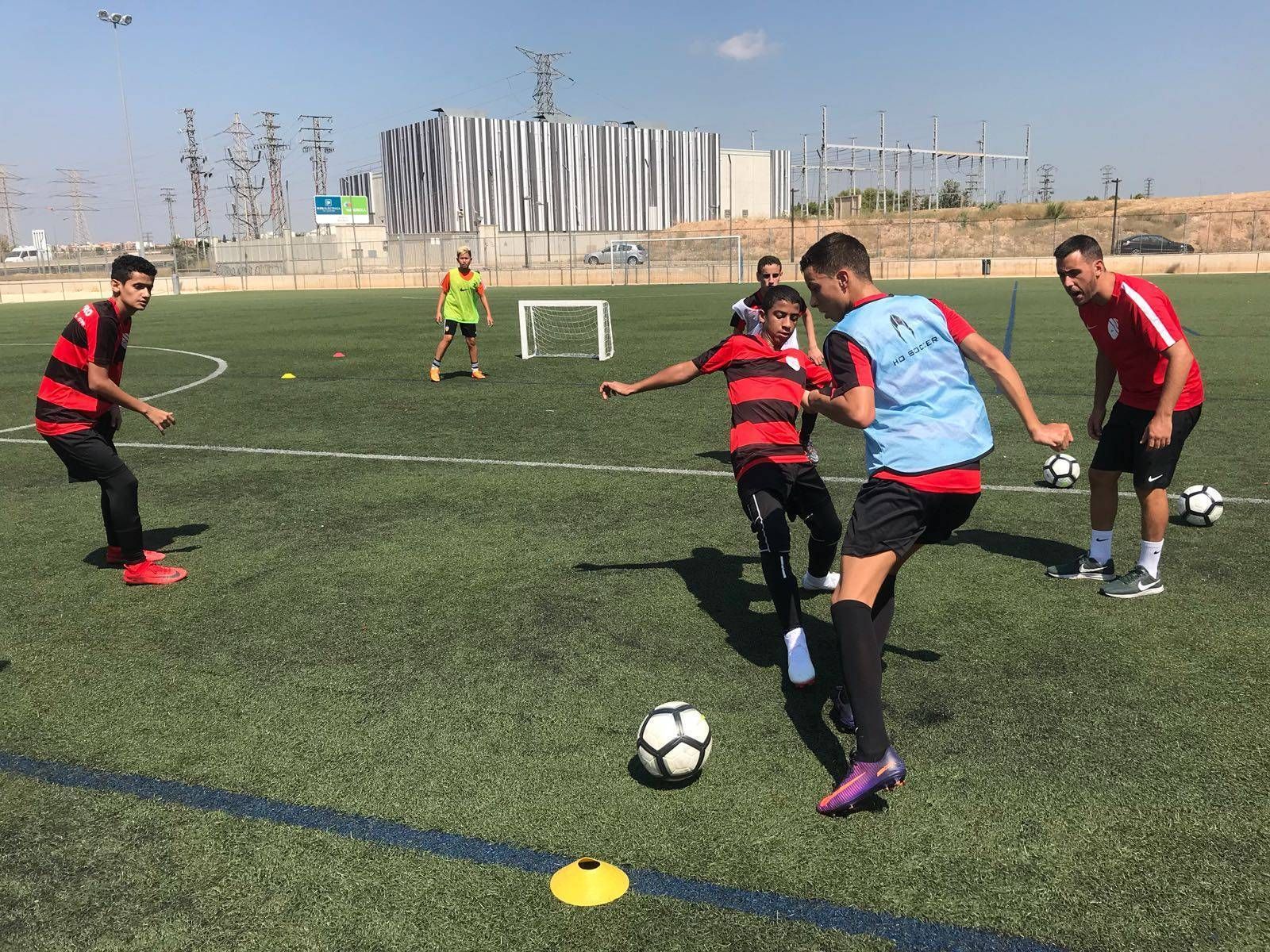 A group of young men are playing soccer on a field.