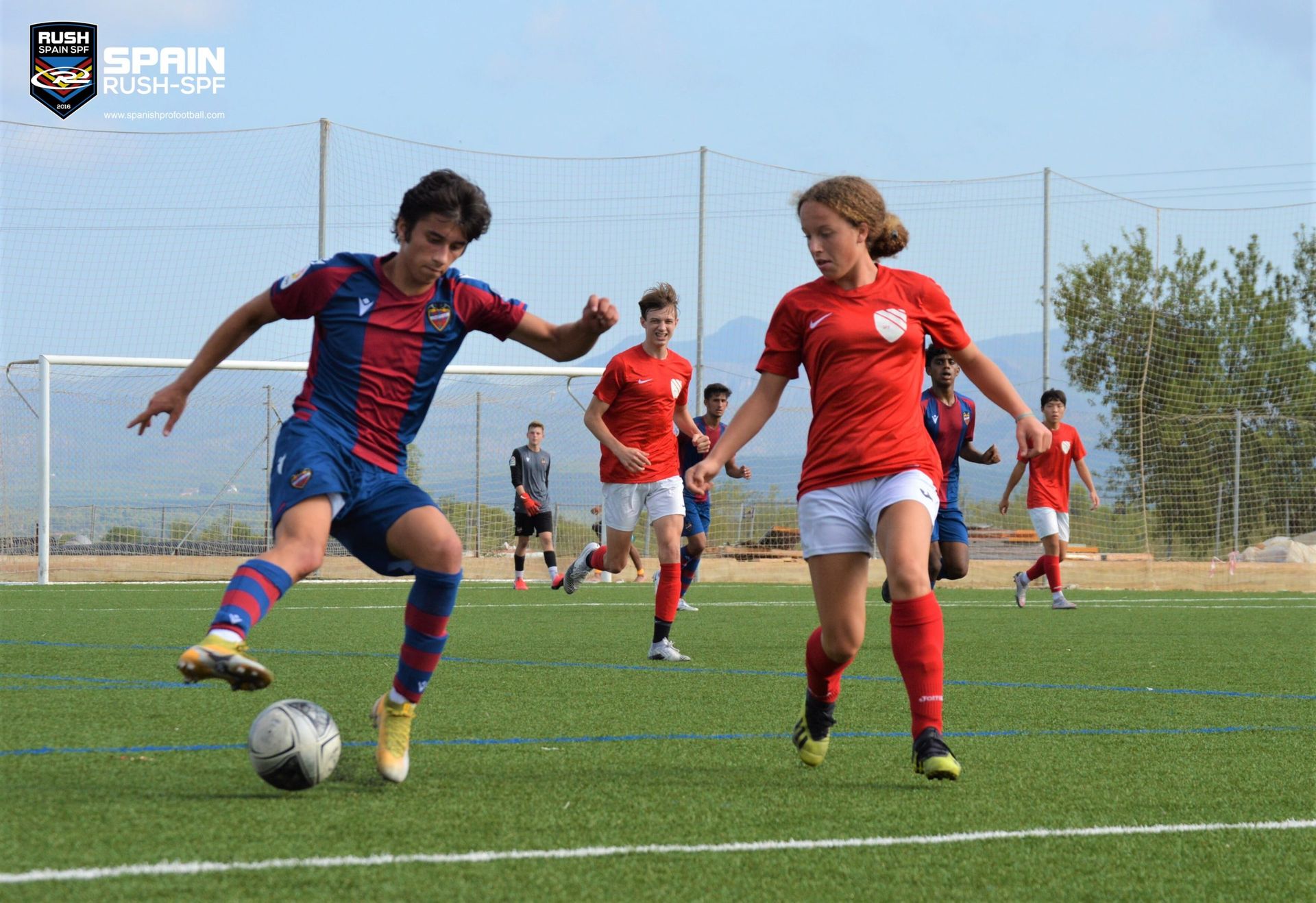 Ava Priest playing soccer against a boy at Spain Rush SPF