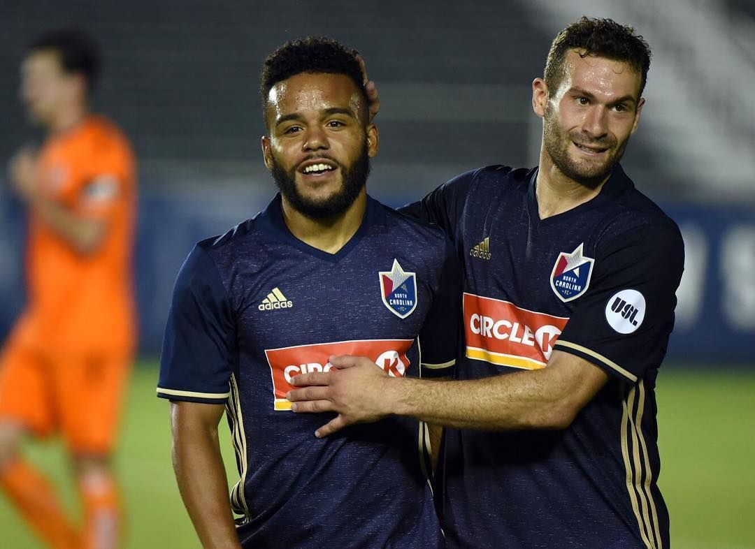 DJ Taylor hugging a teammate on the soccer field