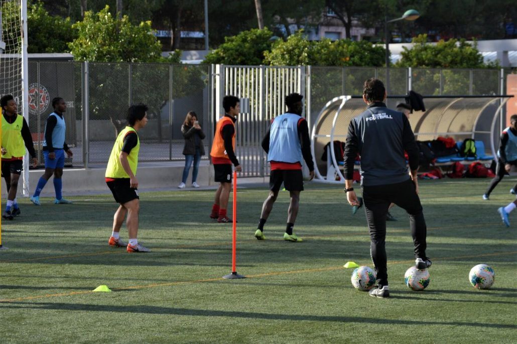 A group of young men are playing soccer on a field.