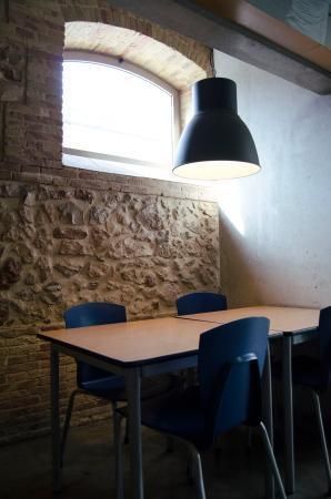 A table and chairs in a room with a brick wall