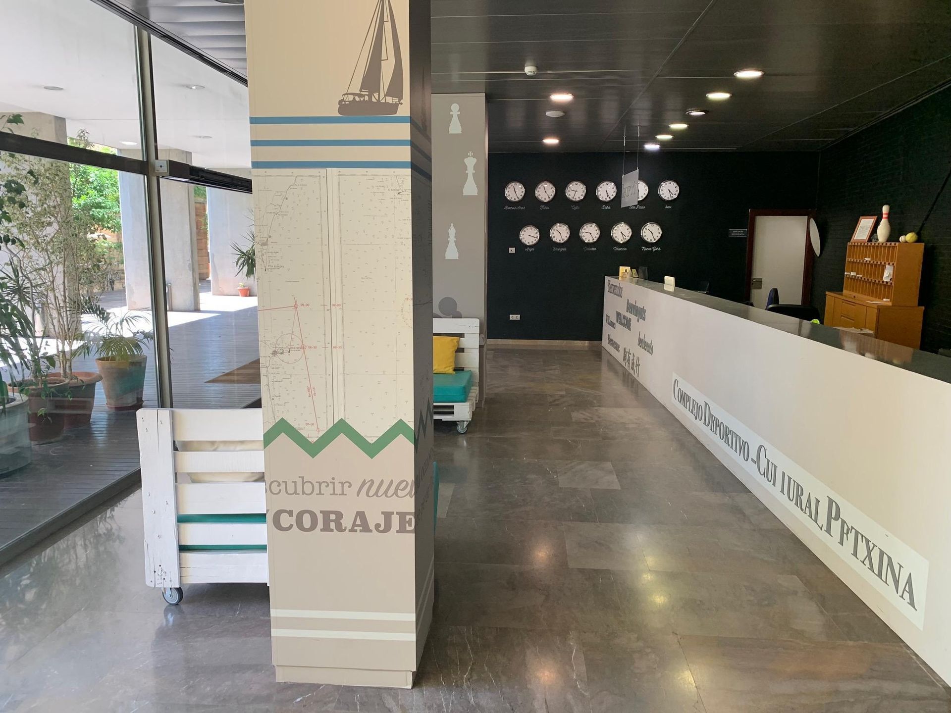 A lobby of a hotel with a sailboat on the wall