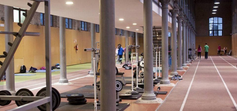 A gym with a track and a lot of exercise equipment