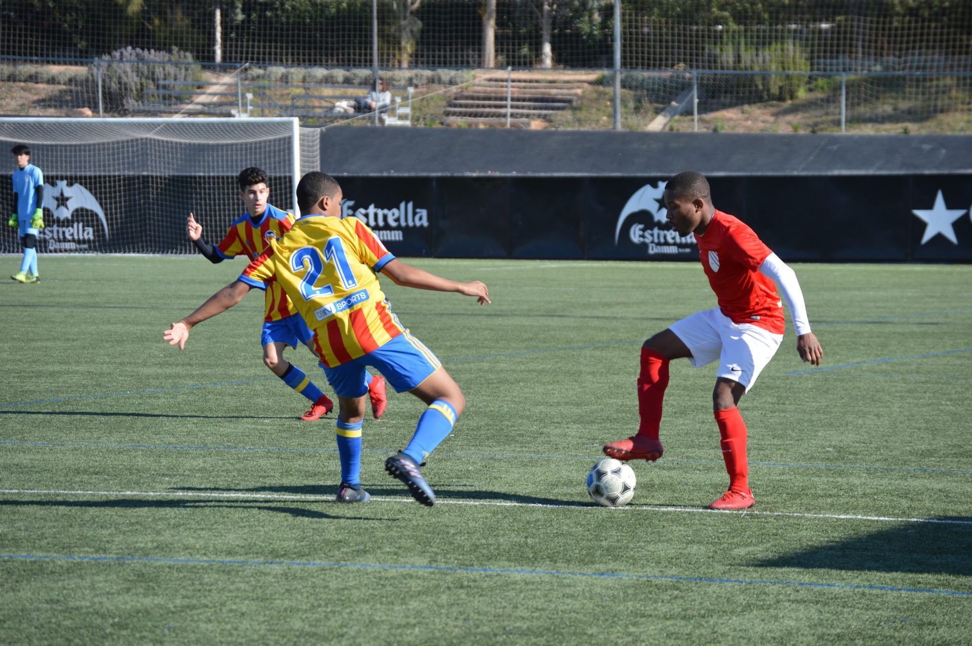 A group of young men are playing soccer on a field.