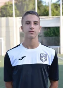 Ori Cohen wearing a black and white soccer jersey is standing on a field.