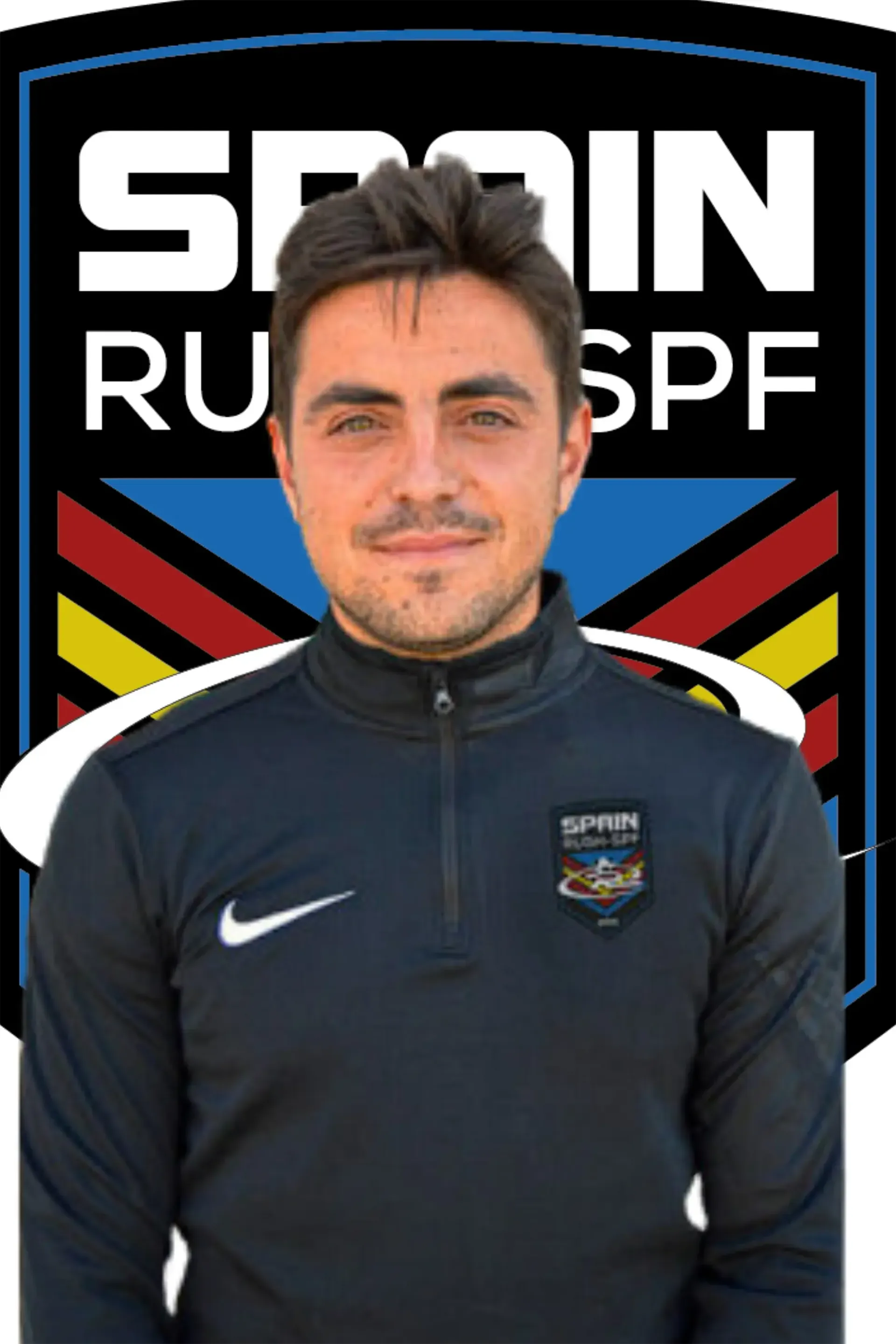 Ruben E Camacho stands in front of a  Spain Rush-SPF logo