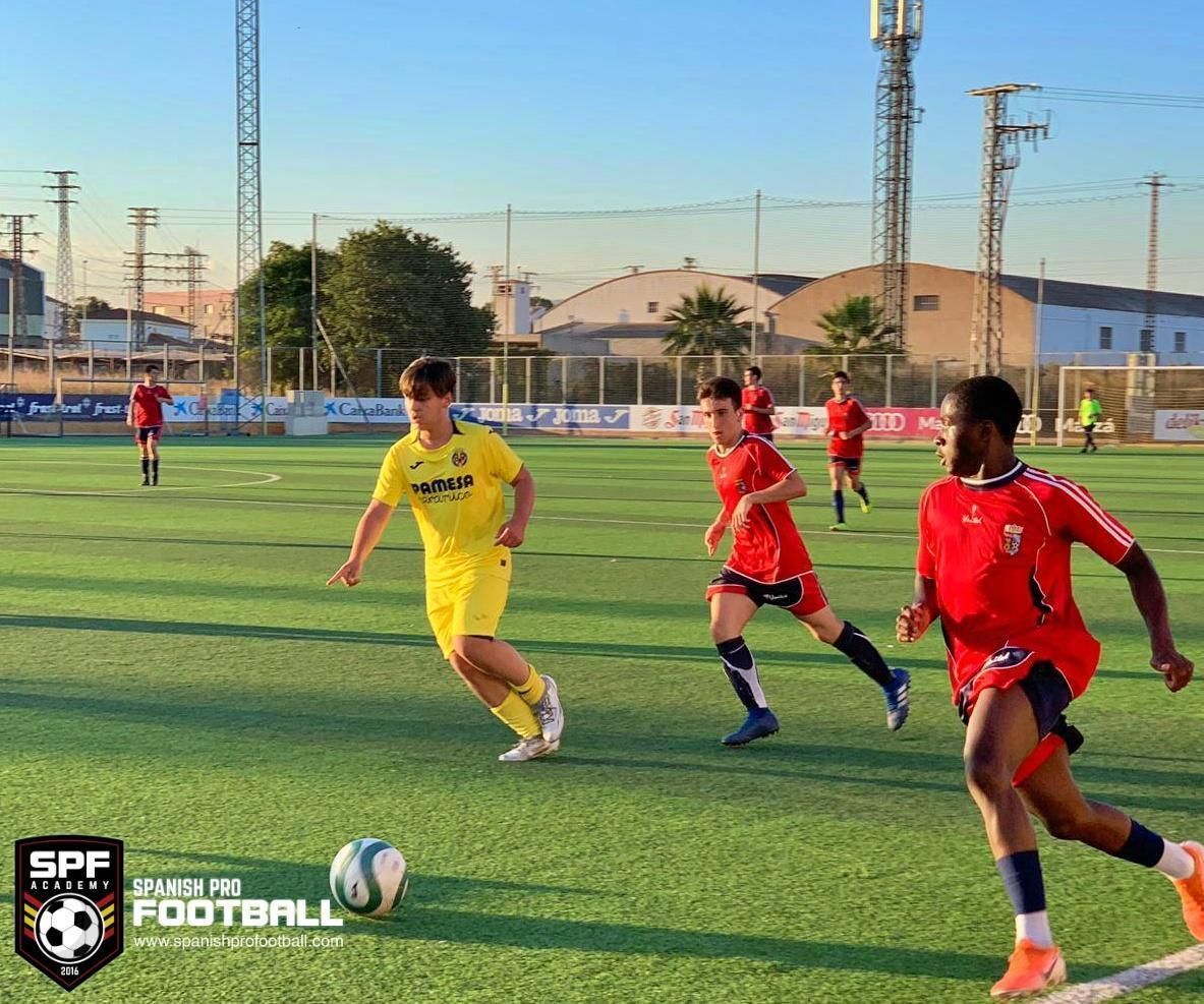 A group of young men are playing soccer on a field.