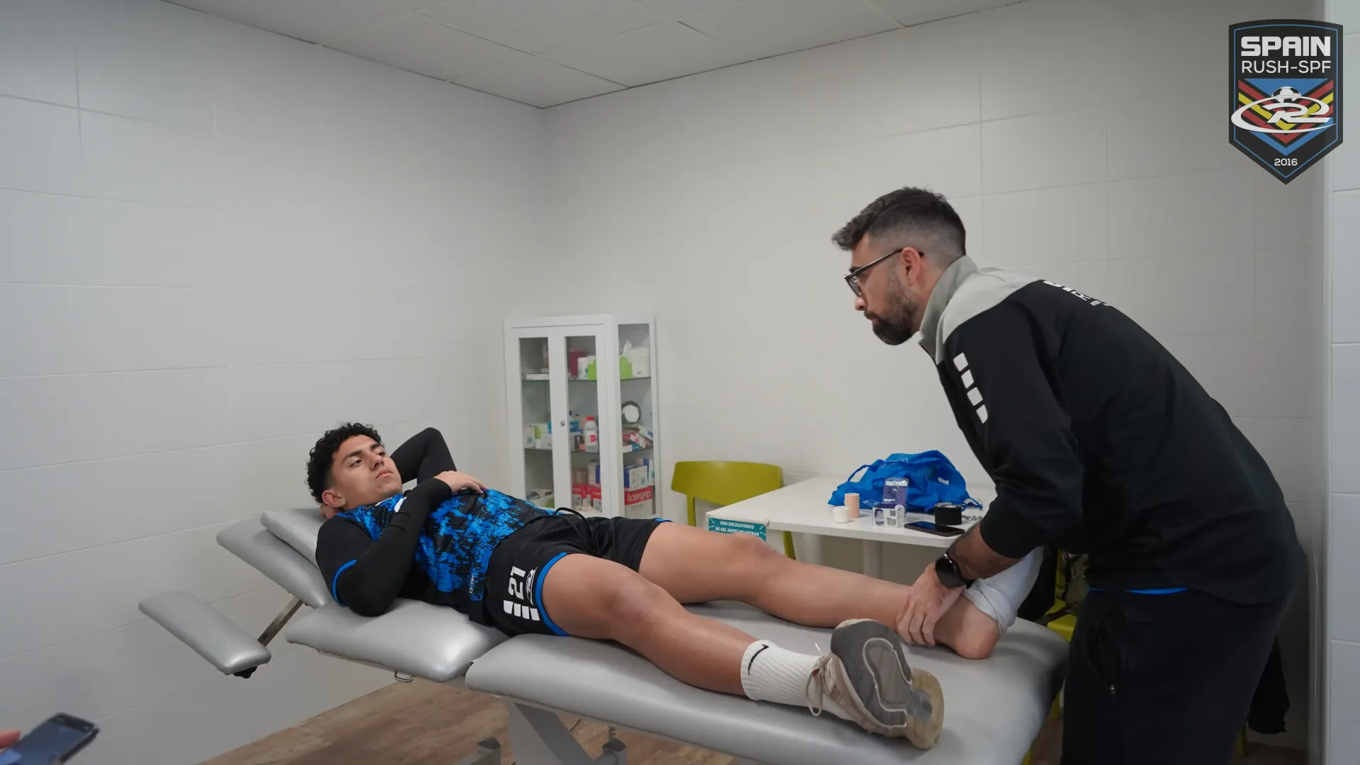 A physical therapist helping a soccer player with an ankle injury