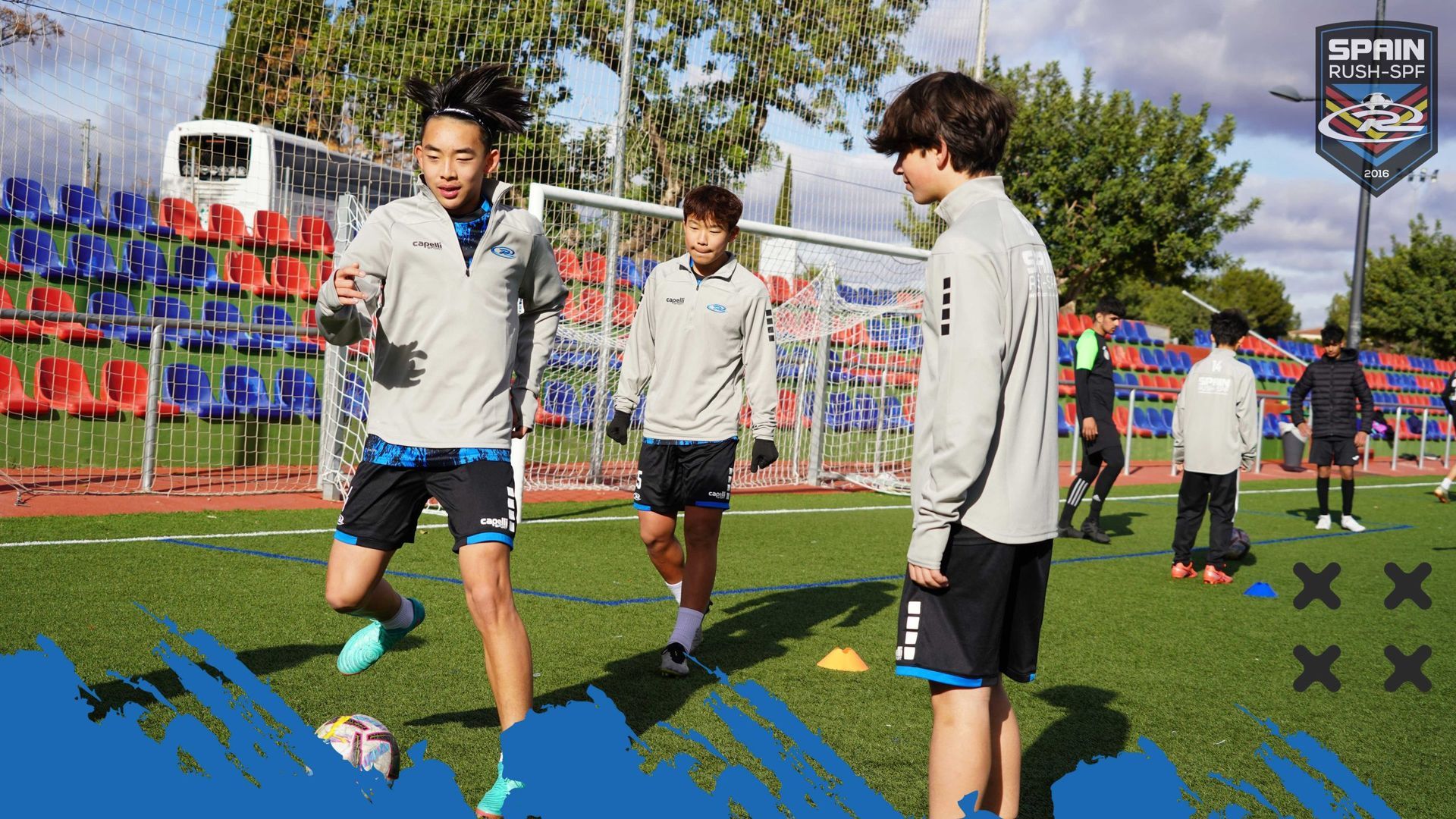 A group of young boys are playing soccer on a field.