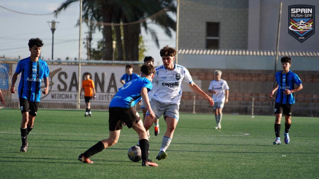 A group of young men are playing soccer on a field.