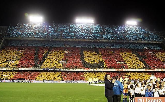 A group of people standing in front of a stadium that says ' llantera ' on it