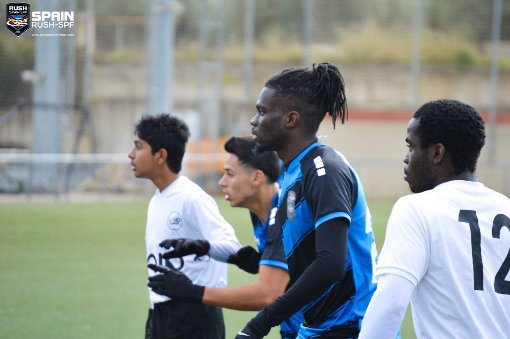 A group of young men are playing soccer on a field.