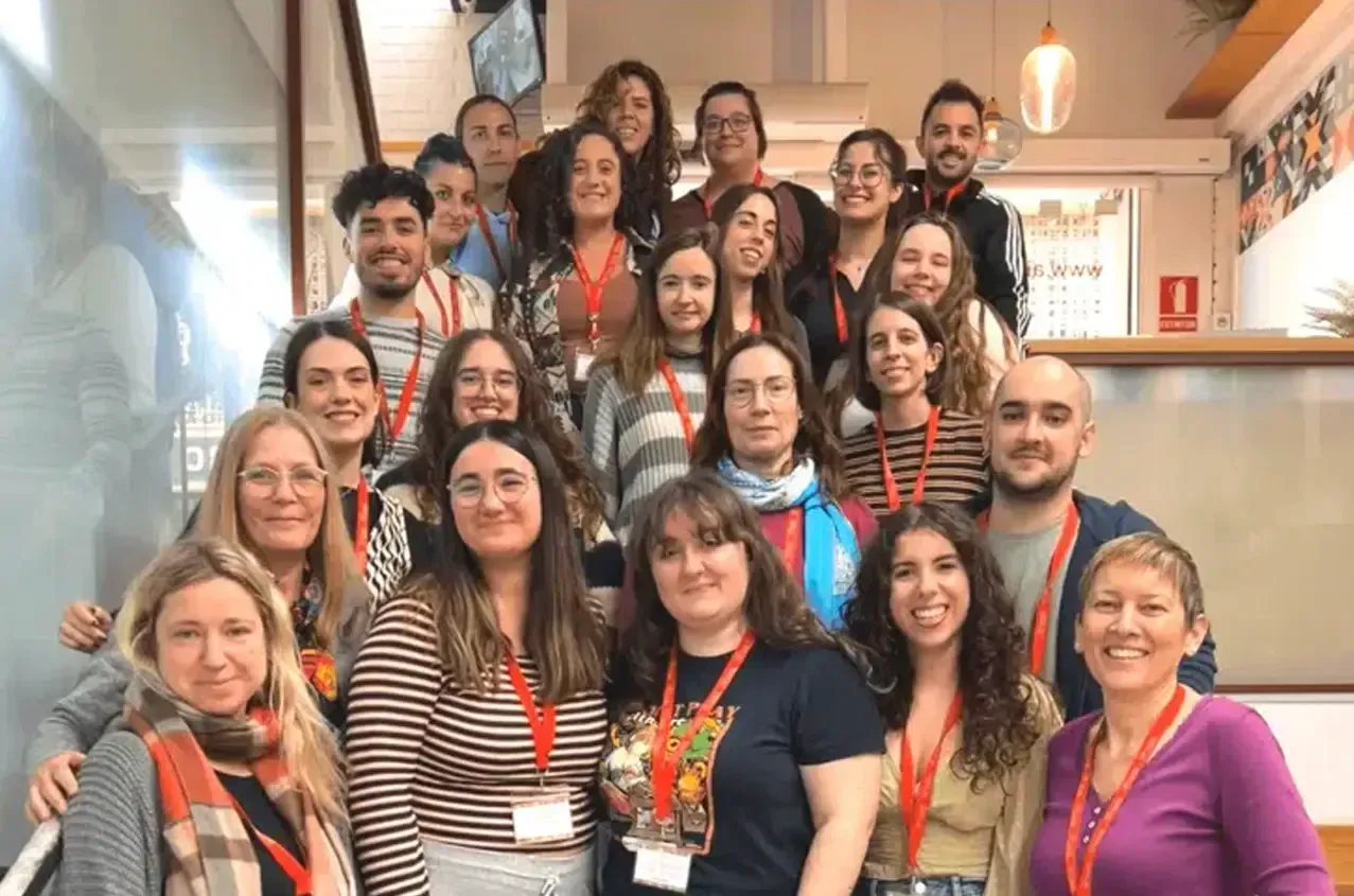 A group of teachers are posing for a picture on a set of stairs.