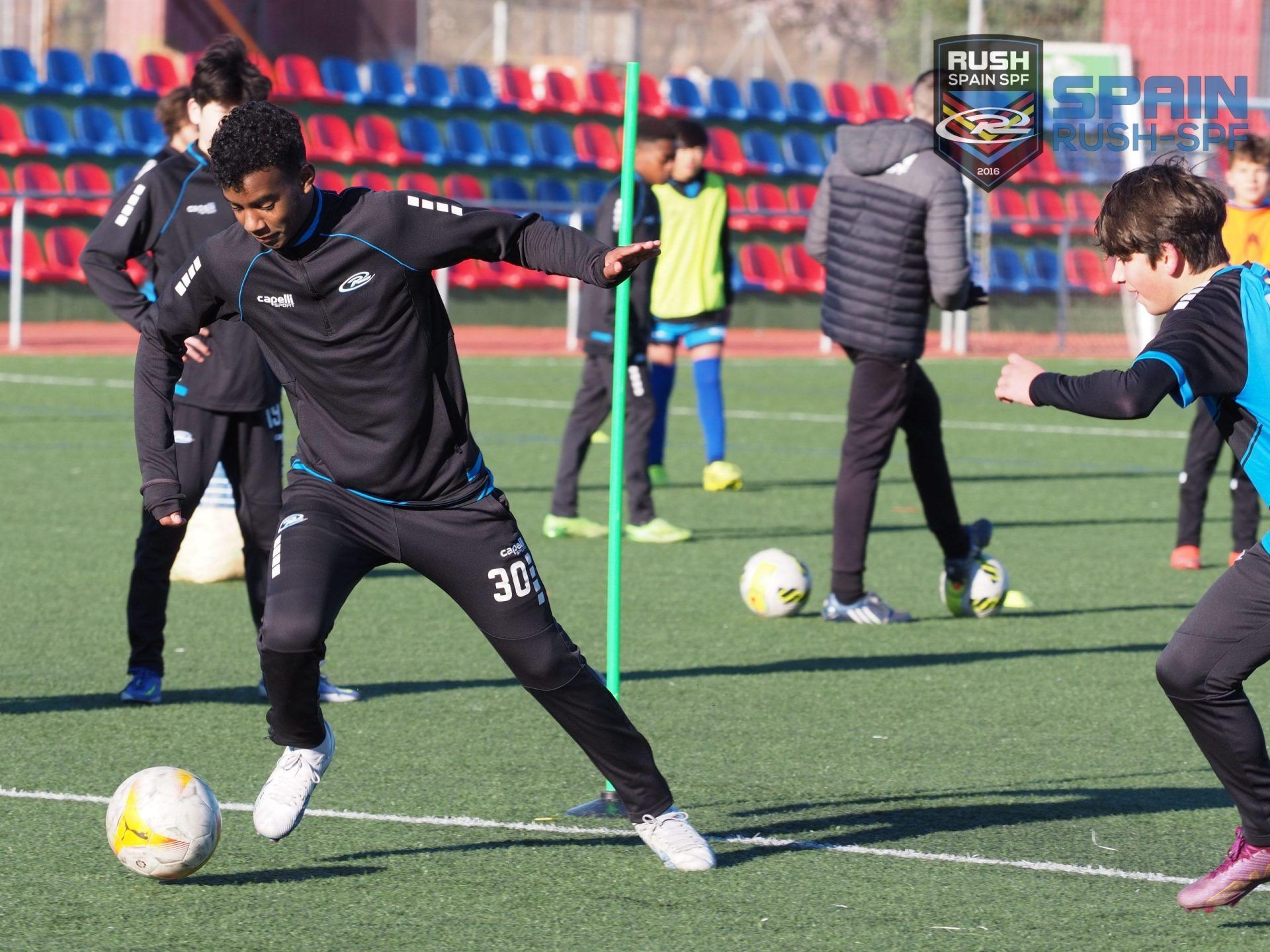 A group of young boys are playing soccer on a field.