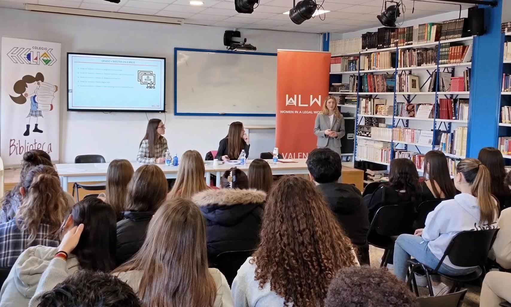 A group of people are sitting in a room watching a presentation.