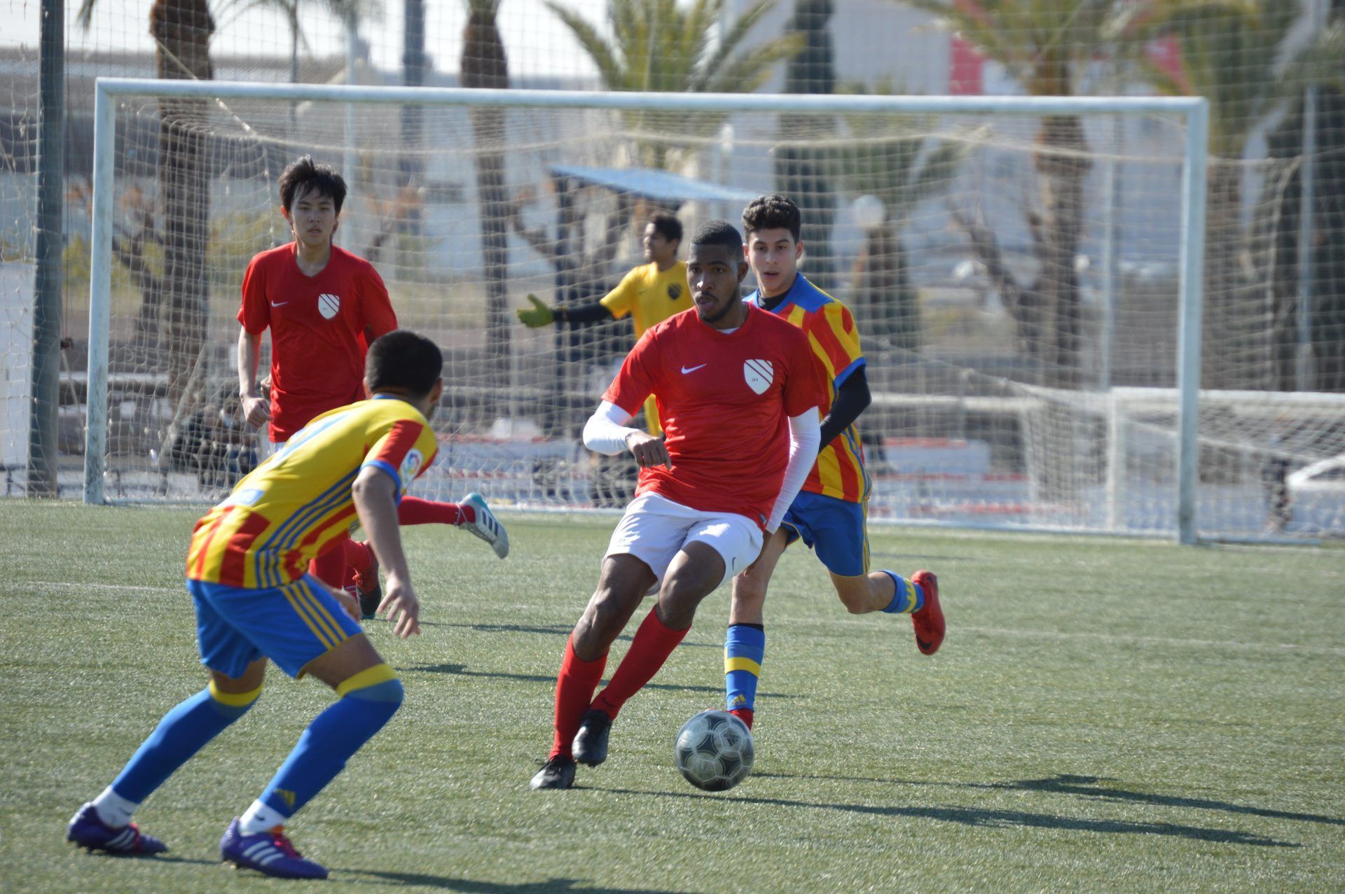 A group of young men are playing soccer on a field.