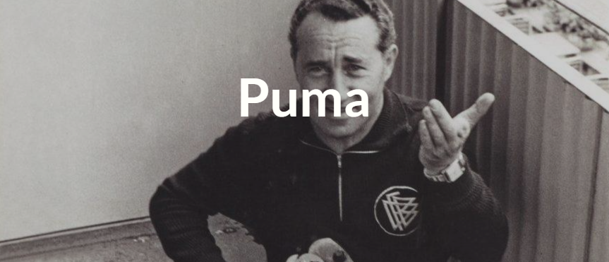 A black and white photo of a man wearing a Puma jacket.