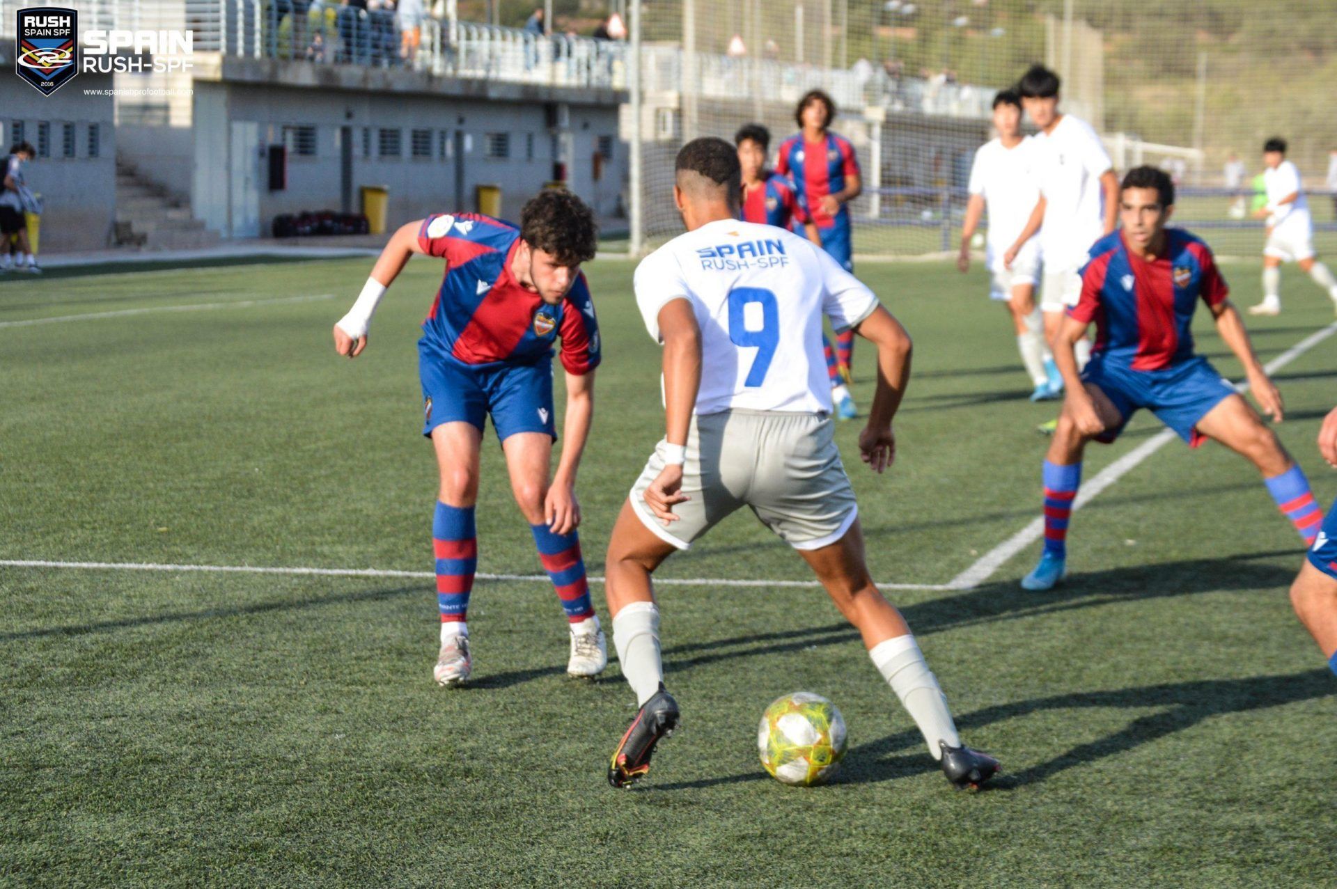 A group of young men are playing soccer on a field.