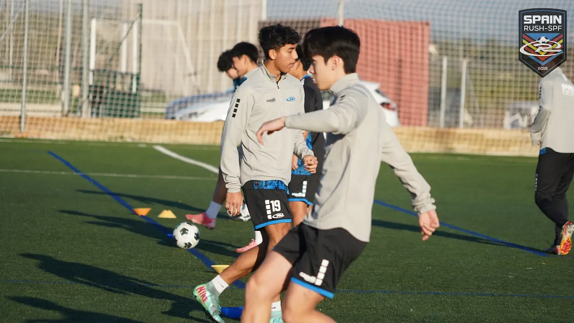 A group of young men are playing soccer on a field.