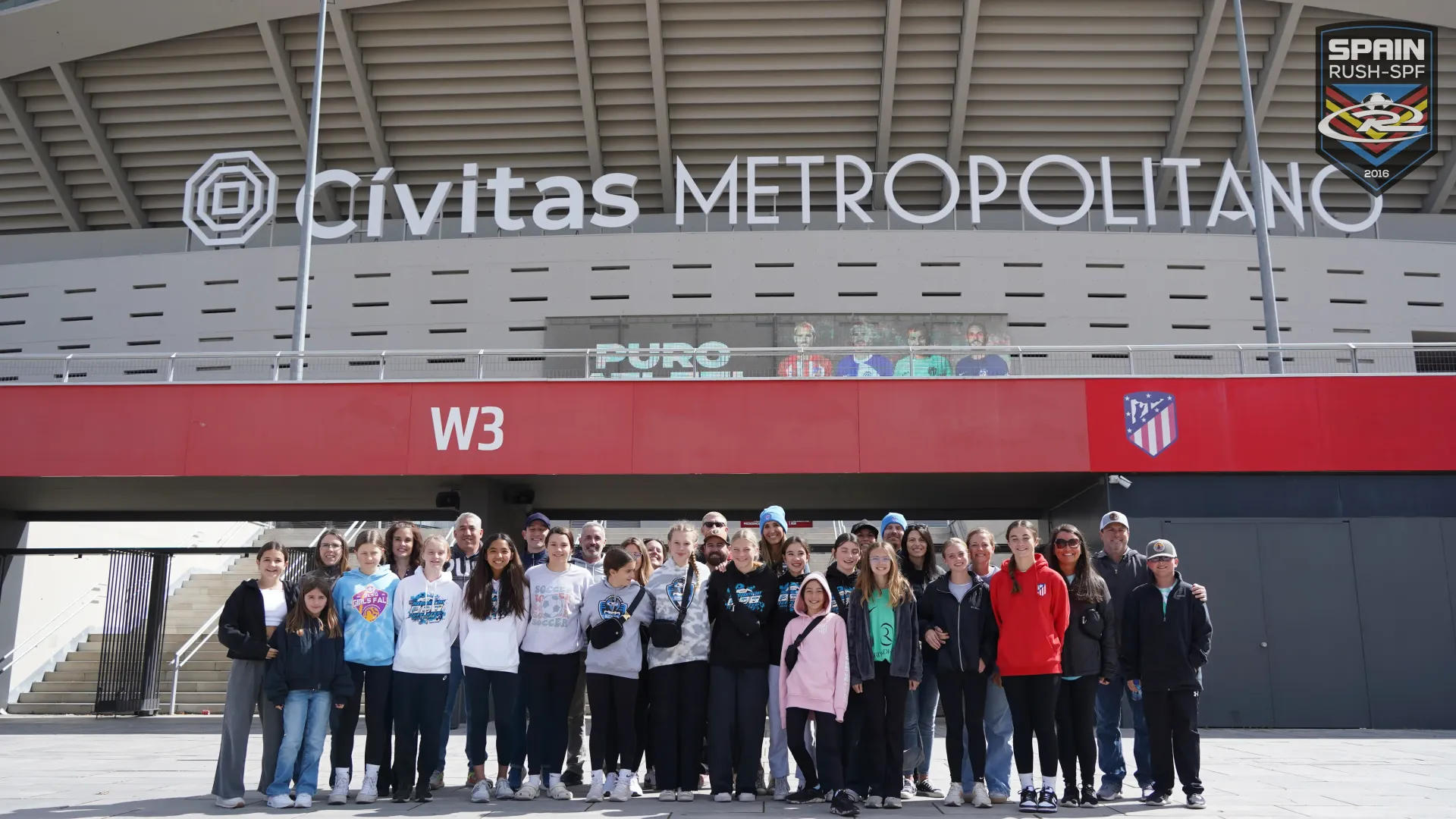 A group of people standing in front of a sign that says civitas metropolitano