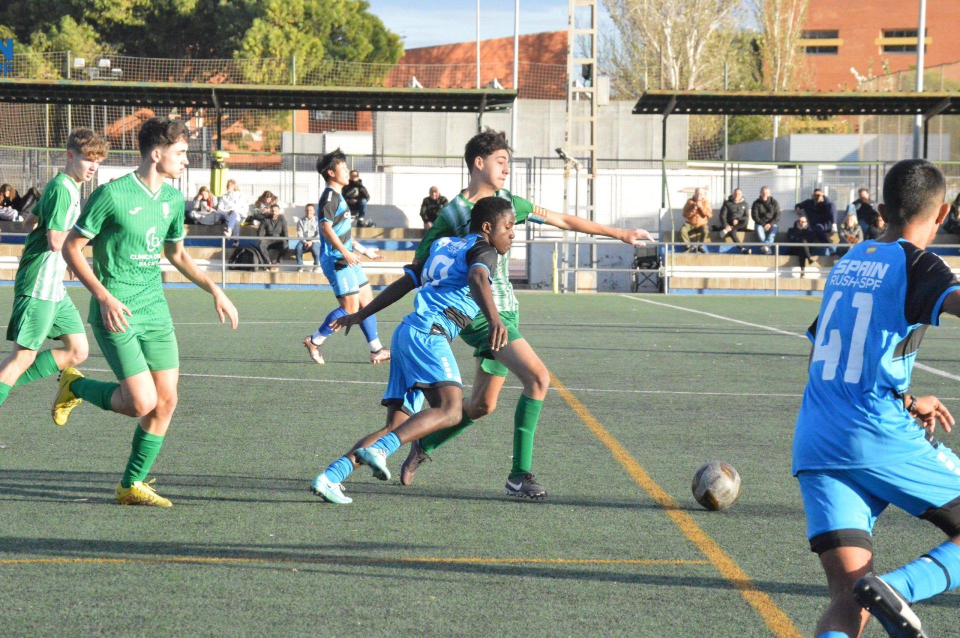 A group of young men are playing soccer on a field.