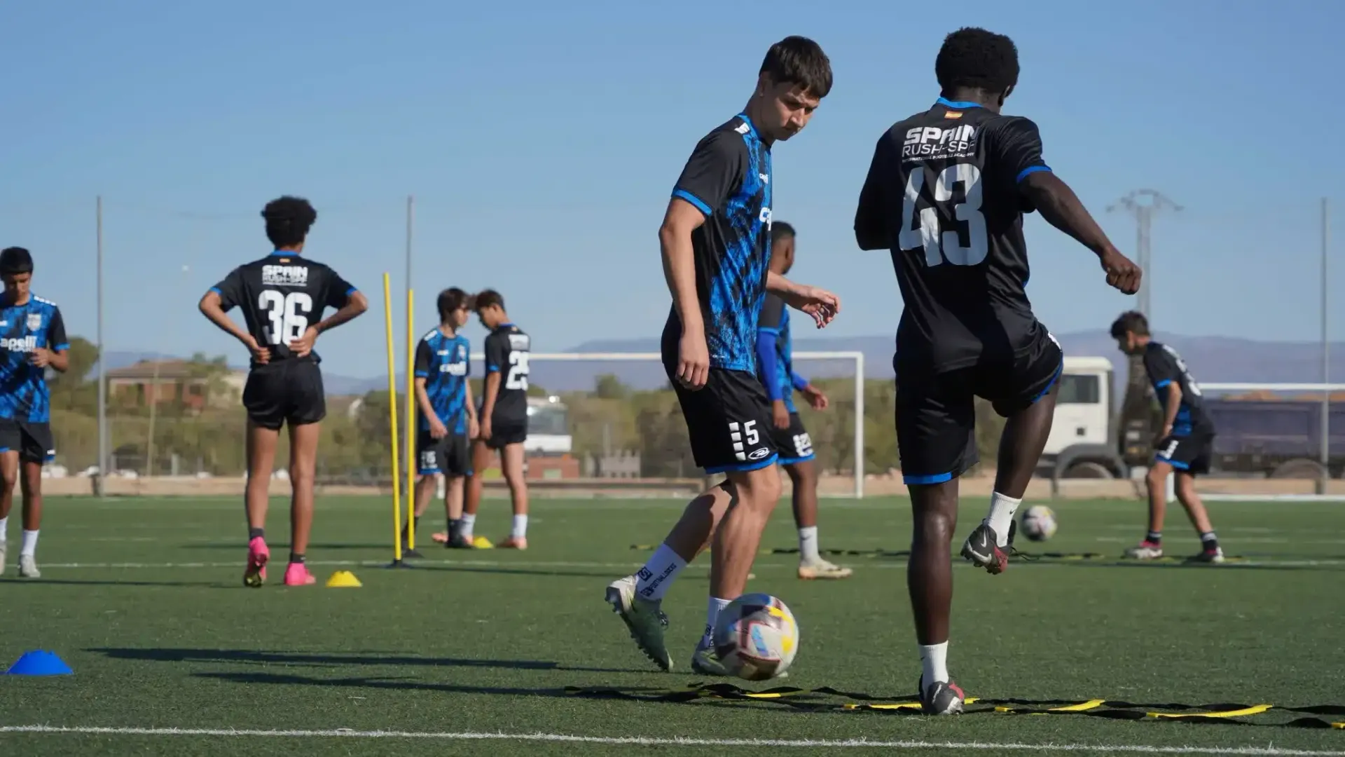 A group of young men are playing soccer on a field.