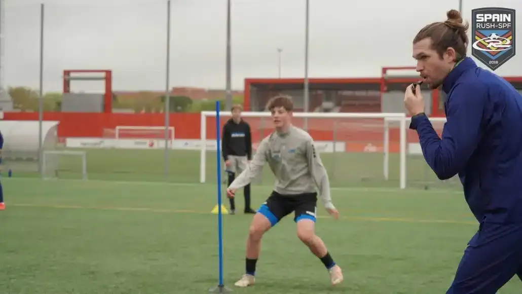 UEFA licensed Spain Rush-SPF coach blowing a whistle during a soccer drill 