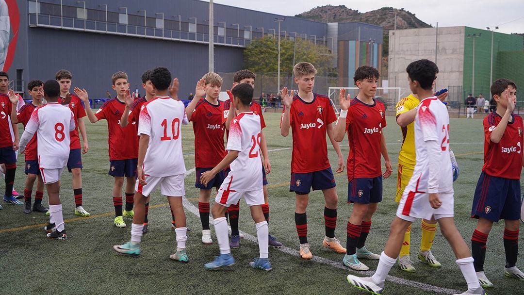 A group of young boys are standing on a soccer field.