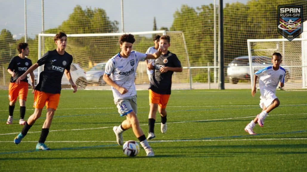 A group of young men are playing soccer on a field.