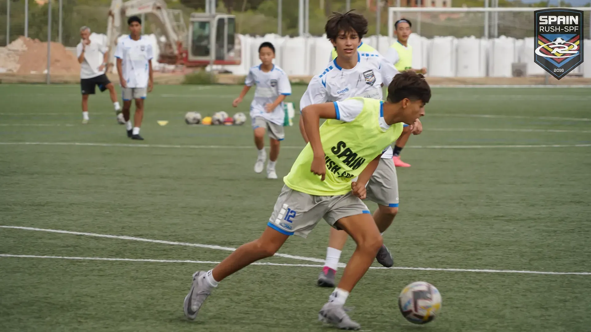 A group of young boys are playing soccer on a field.