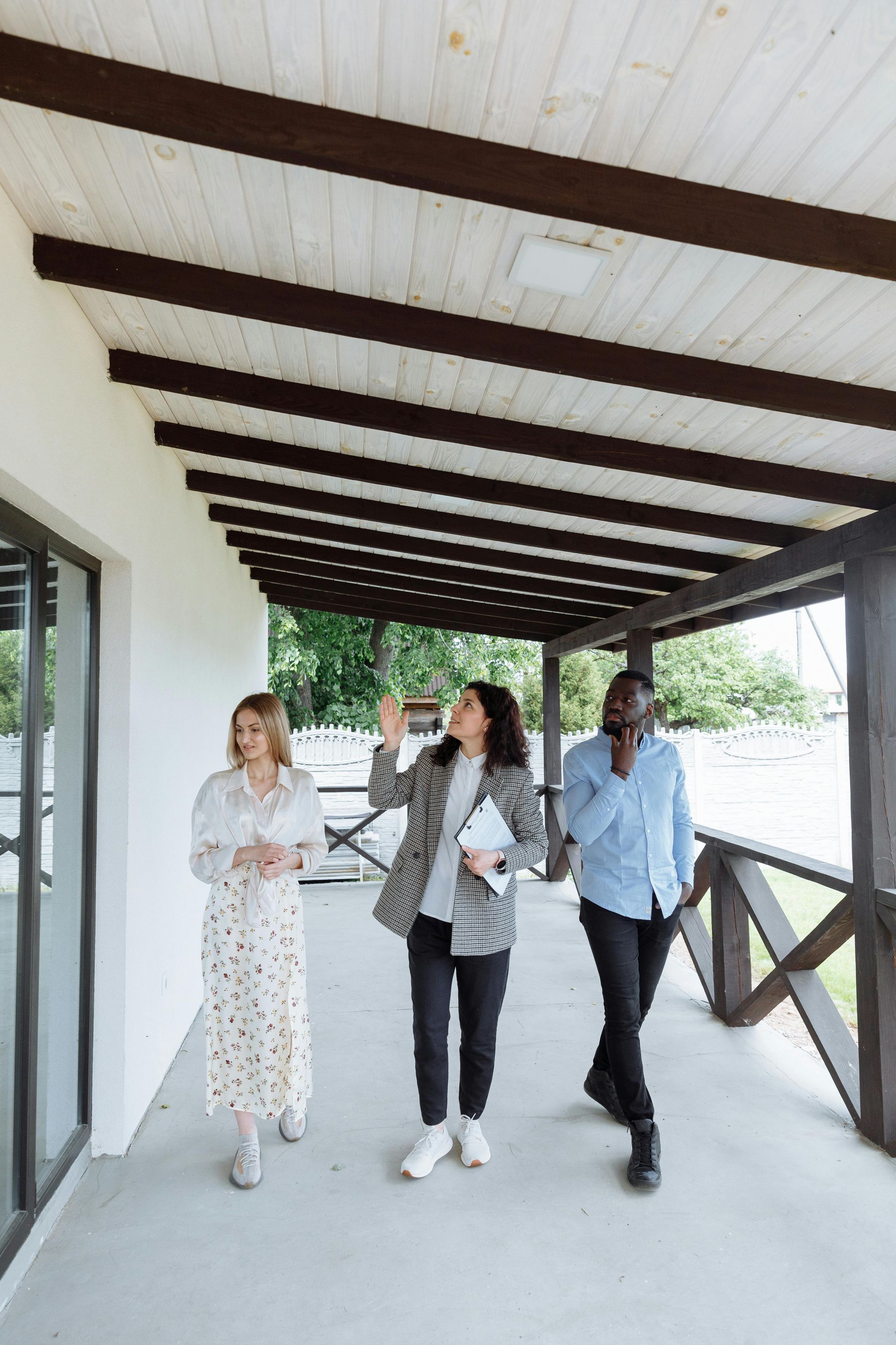 A group of people are walking down a porch.