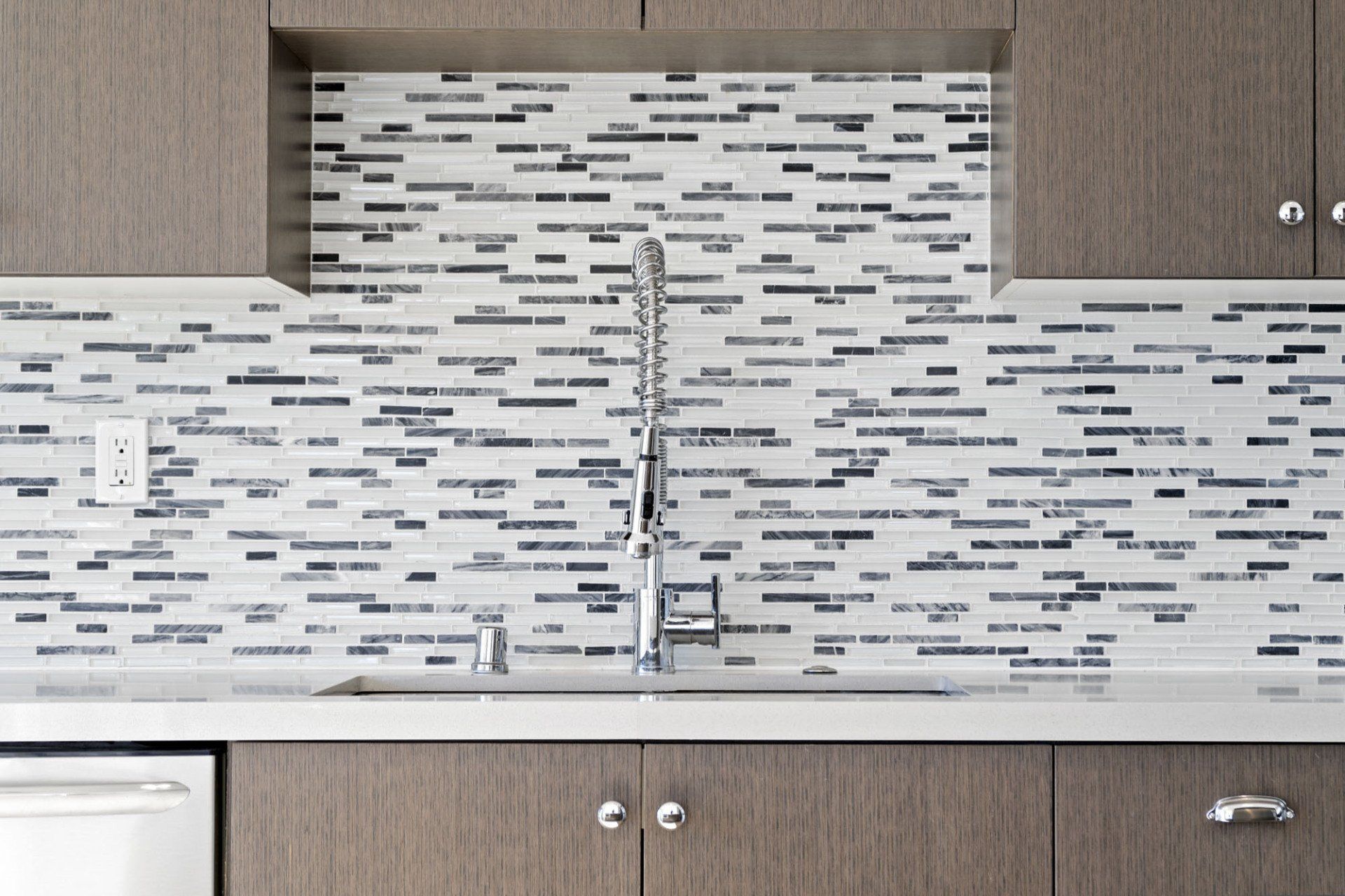 Interior of kitchen sink and tile back splash